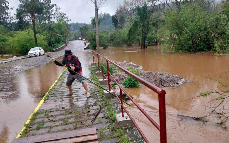 JosÃ© Valcir Carvalho da Cruz, 63 anos, ajudando por conta prÃ³pria desobstruir passam de Ã¡gua obstruÃ­da por pallets