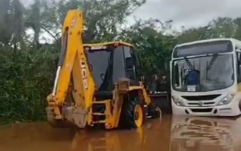 Estudantes sÃ£o resgados de Ã´nibus por patrola em trecho inundado de estrada em Lomba Grande 