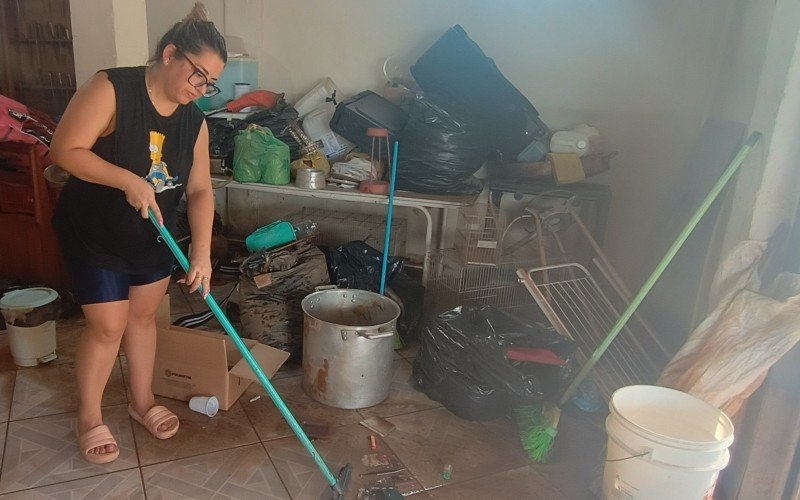 Paula Castro está há dois dias limpando a lama que invadiu a casa junto com a água poluída