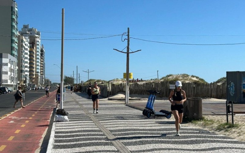 Ressaca do mar persiste e veranistas trocam faixa de areia por calçadão à beira-mar para praticar atividades físicas
