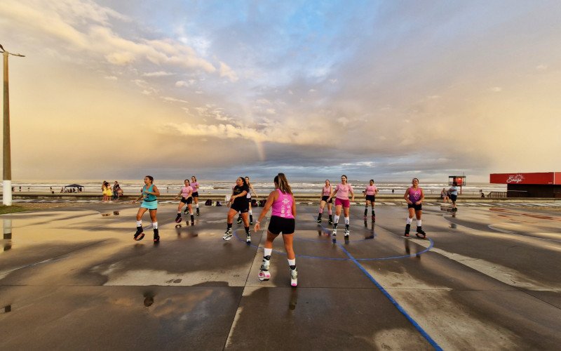 Fim do dia com arco-íris e sol se pondo é cenário para as aulas ao ar livre em Tramandaí